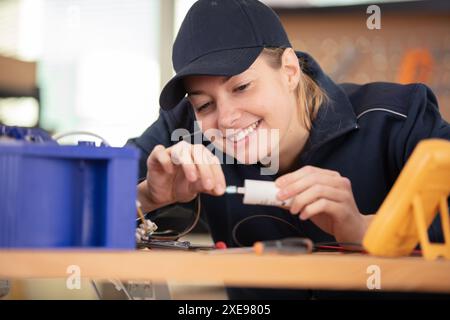 female technician connecting cables into ventilation unit Stock Photo