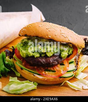 Burger with french fries on wooden tray Stock Photo