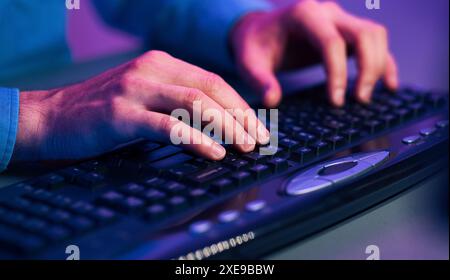Close Up of Hands Typing on a Black Keyboard Stock Photo
