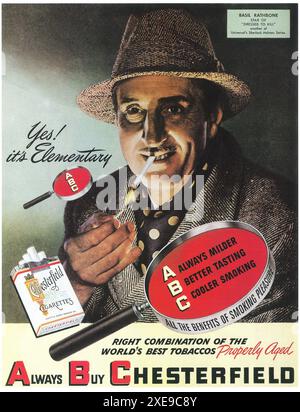 BASIL RATHBONE as SHERLOCK HOLMES in his latest adventure DRESSED TO KILL  smoking CHESTERFIELD CIGARETTES 1946 Magazine Advertisement Stock Photo