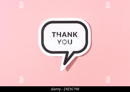 Thank you text on speech bubble isolated on pink background Stock Photo