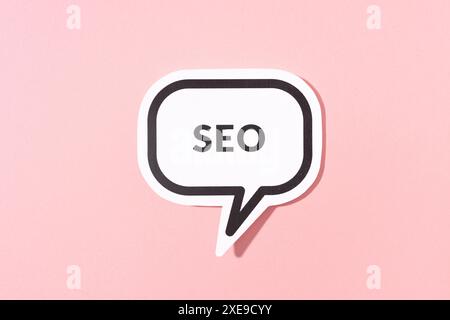 SEO text on speech bubble isolated on pink background Stock Photo