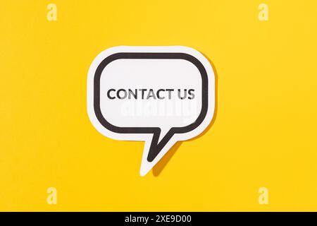 Contact Us text on speech bubble isolated on yellow background Stock Photo
