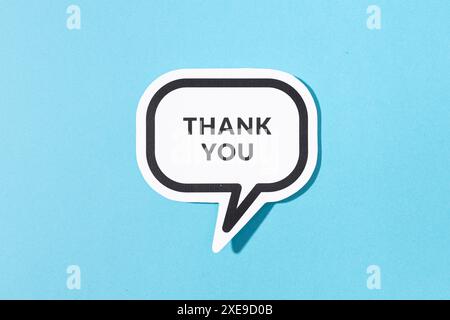 Thank you text on speech bubble isolated on blue background Stock Photo