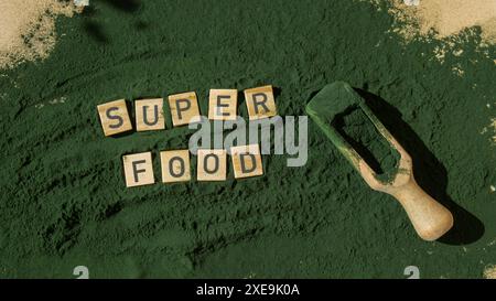 SUPERFOOD letter chlorella on green background of algae superfood. Organic blue-green algae spirulina powder food. Healthy benef Stock Photo