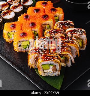 Big set of rolls with wasabi and pickled ginger on stone serving board Stock Photo