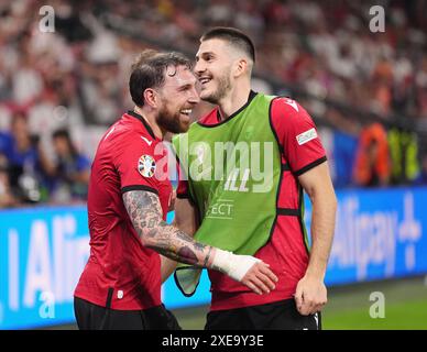 Georgia's Guram Kashia (right) celebrates with teammate Luka Lochoshvili during the UEFA Euro 2024 Group F match at the Arena AufSchalke in Gelsenkirchen, Germany. Picture date: Wednesday June 26, 2024. Stock Photo