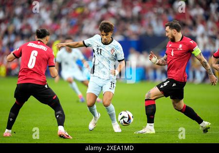 Georgia's Giorgi Kochorashvili, Portugal's Joao Felix, and Georgia's Guram Kashia in action during the UEFA Euro 2024 Group F match at the Arena AufSchalke in Gelsenkirchen, Germany. Picture date: Wednesday June 26, 2024. Stock Photo