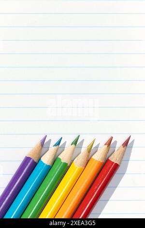 Pride flag created by a group of colored pencils on white lined paper. Copy space Stock Photo