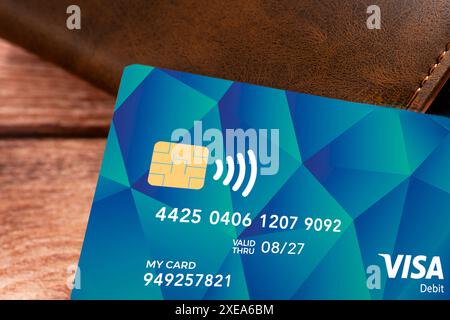 Germany - June 26, 2024: Payment card for refugees and asylum seekers in Germany. Social card lying on a purse or wallet on a table. PHOTOMONTAGE *** Bezahlkarte für Geflüchtete Personen und Flüchtlinge, bzw. Asylanten in Deutschland. Social-Card liegt auf einem Geldbeutel, bzw. einer Geldbörse auf einem Tisch. FOTOMONTAGE Stock Photo