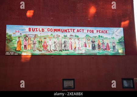 Building community act for peace mural in downtown Saint John, New Brunswick, Canada Stock Photo