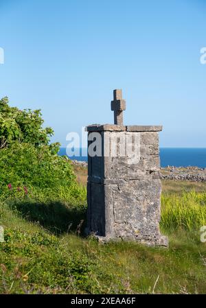 Traditional burial cross, situated along the roadside in Inishmore Island, Aran Islands, Galway County, West Ireland coast Stock Photo