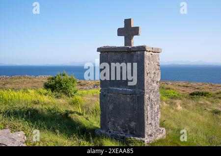 Traditional burial cross, situated along the roadside in Inishmore Island, Aran Islands, Galway County, West Ireland coast Stock Photo