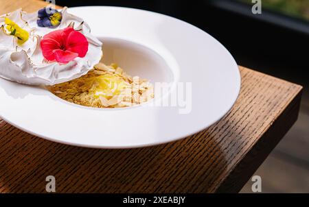 Meringue on plate and almonds with vanilla custard Stock Photo