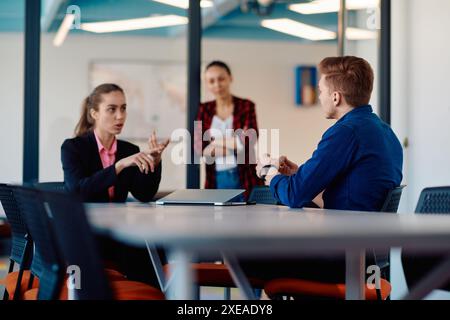 A team of successful programmers sits in a startup office, strategizing new business projects and solving existing challenges, s Stock Photo