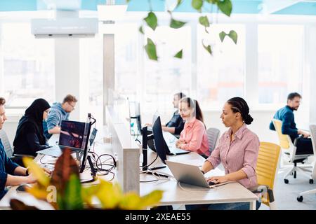 Collaborative process of multicultural skilled young business team during brainstorming meeting in office.Diverse group of young Stock Photo