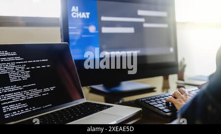 AI chat bot, Programmer using generative artificial intelligence for software development inside office. Virtual chatBot technology trend Stock Photo