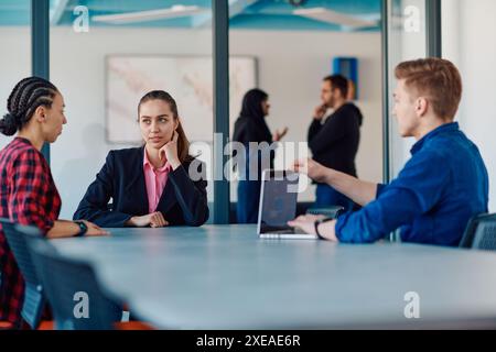 A team of successful programmers sits in a startup office, strategizing new business projects and solving existing challenges, s Stock Photo