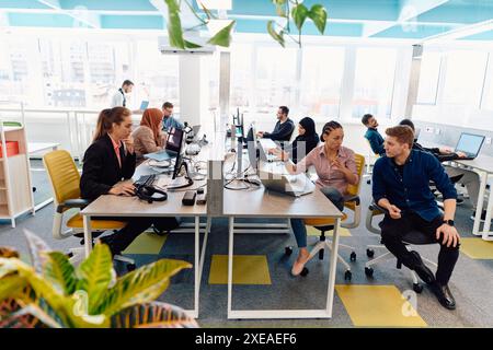 Collaborative process of multicultural skilled young business team during brainstorming meeting in office.Diverse group of young Stock Photo