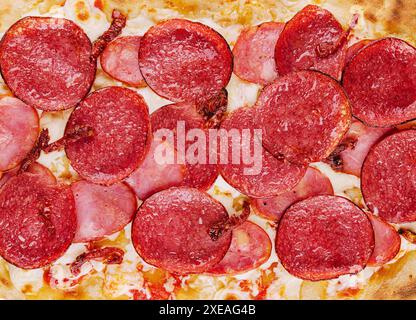 Pepperoni pizza close up background or texture Stock Photo