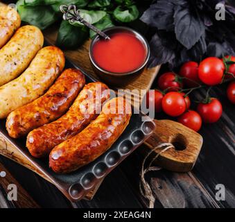 Grilled sausages and vegetables close up Stock Photo