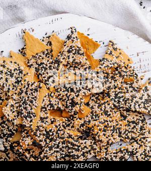 Salted tortilla chips triangle with chia seeds on top view Stock Photo