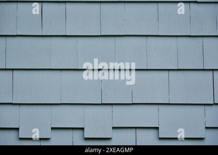 Background of painted gray blue cedar shingle. Exterior wall wood siding. Stock Photo