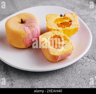Two small french mousse cake apple shaped dome served on a plate Stock Photo