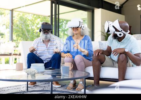 At home, Diverse group of friends using VR headsets, enjoying virtual reality experience Stock Photo