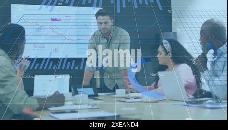 Image of statistical data processing against caucasian man discussing with colleagues at office Stock Photo