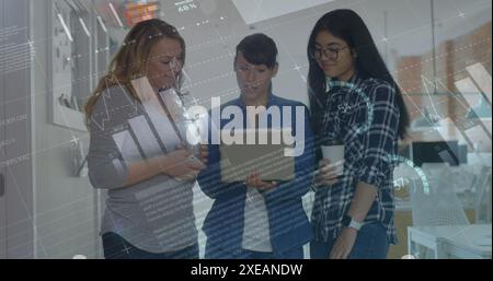Image of statistical data processing over three diverse women discussing over a laptop at office Stock Photo