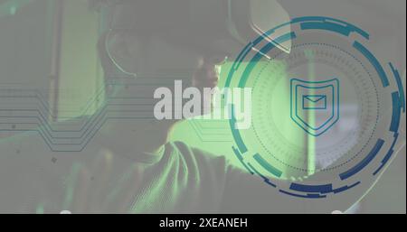 Image of envelope in shield and loading circles, biracial man using vr headset Stock Photo