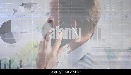 Image of statistical data processing against caucasian man talking on smartphone at office Stock Photo