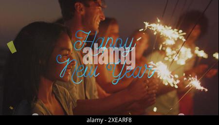 Image of happy new year text over diverse friends with sparklers at party Stock Photo