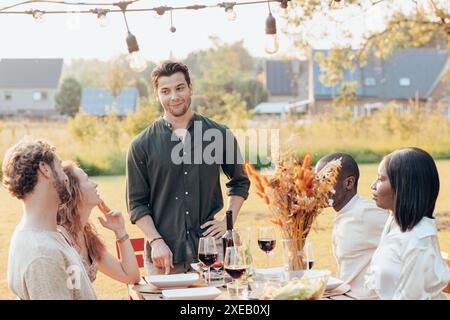 Golden Hour Banter: A Charming Dinner Among Friends Stock Photo