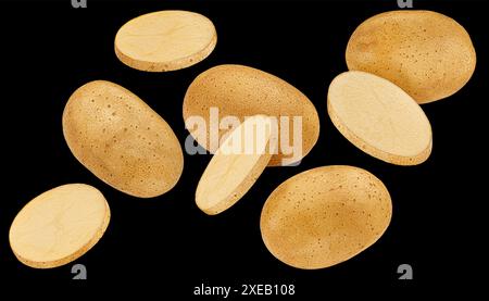 Whole and sliced potatoes on black background Stock Photo