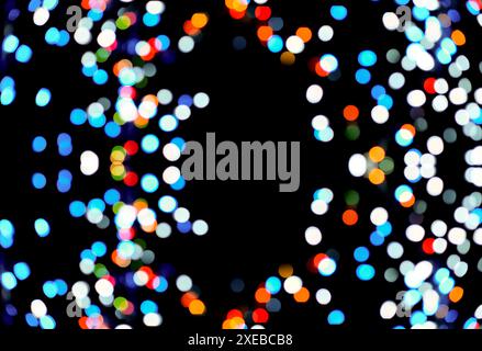 Multi-colored bokeh on a black background, blurry lights of light bulbs Stock Photo
