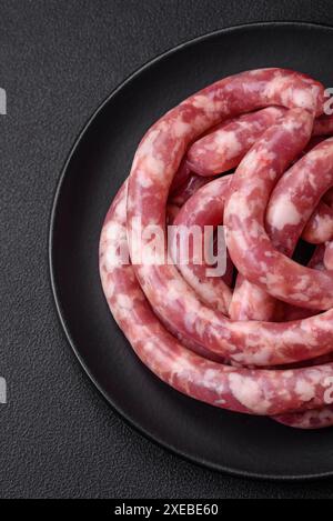 Raw sausages from pork or beef with salt, spices and herbs Stock Photo