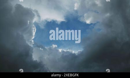 Storm clouds and hole with blue sky Stock Photo