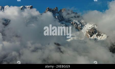 Flying through clouds between mountains Stock Photo