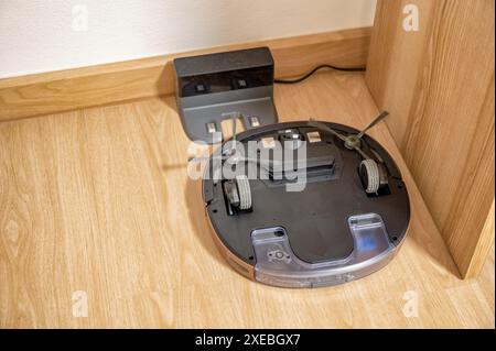 Robot vacuum cleaner turnover not working on rubber tile in bedroom Stock Photo