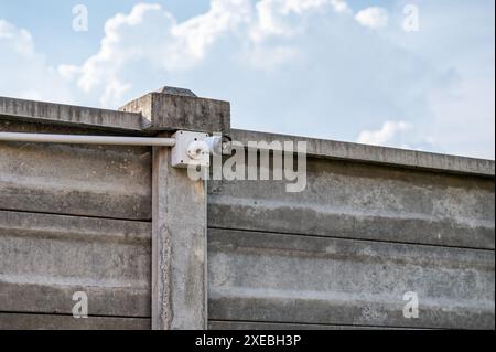 Modern CCTV security camera system install on cement wall with blue sky Stock Photo