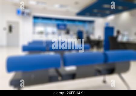 Blurred scene of modern bank with blue seat, counter cashier background Stock Photo