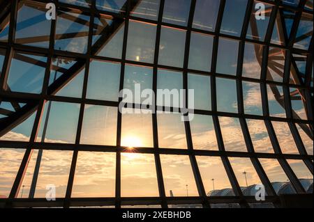 Steel striped pattern structure aerodrome hall at international airport in the sunset Stock Photo