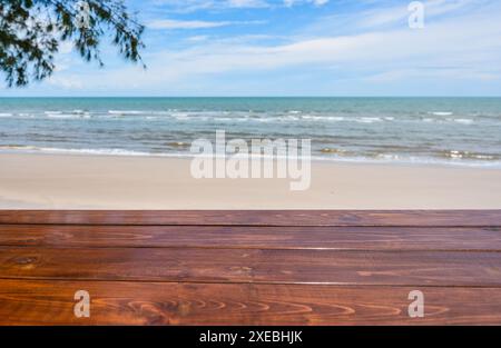 Wooden table top on blurred tropical sea beach on summertime background Stock Photo