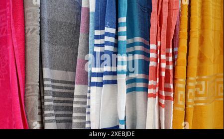 New clean bathrobes are hanging on hangers in the spa salon. Clean towels and aroma candles in the aromatherapy room. A shop selling towels. Stock Photo