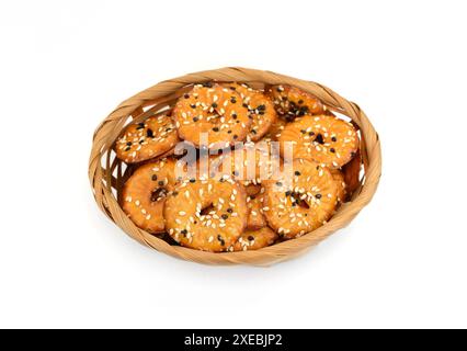 Salted round pretzels with black and white sesame isolated on white. Cracker chips with sea salt isolated on white background. Round shape appetizers. Stock Photo