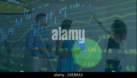 Image of statistical, stock market data processing over diverse colleagues discussing at office Stock Photo