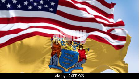 New Jersey state flags waving with the american flag on a clear day Stock Photo