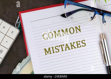 Common Mistakes, business motivational inspirational quotes, words COMMON MISTAKES in an open business notebook Stock Photo